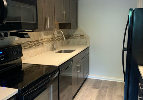 Kitchen with dark cabinets and white quartz countertop